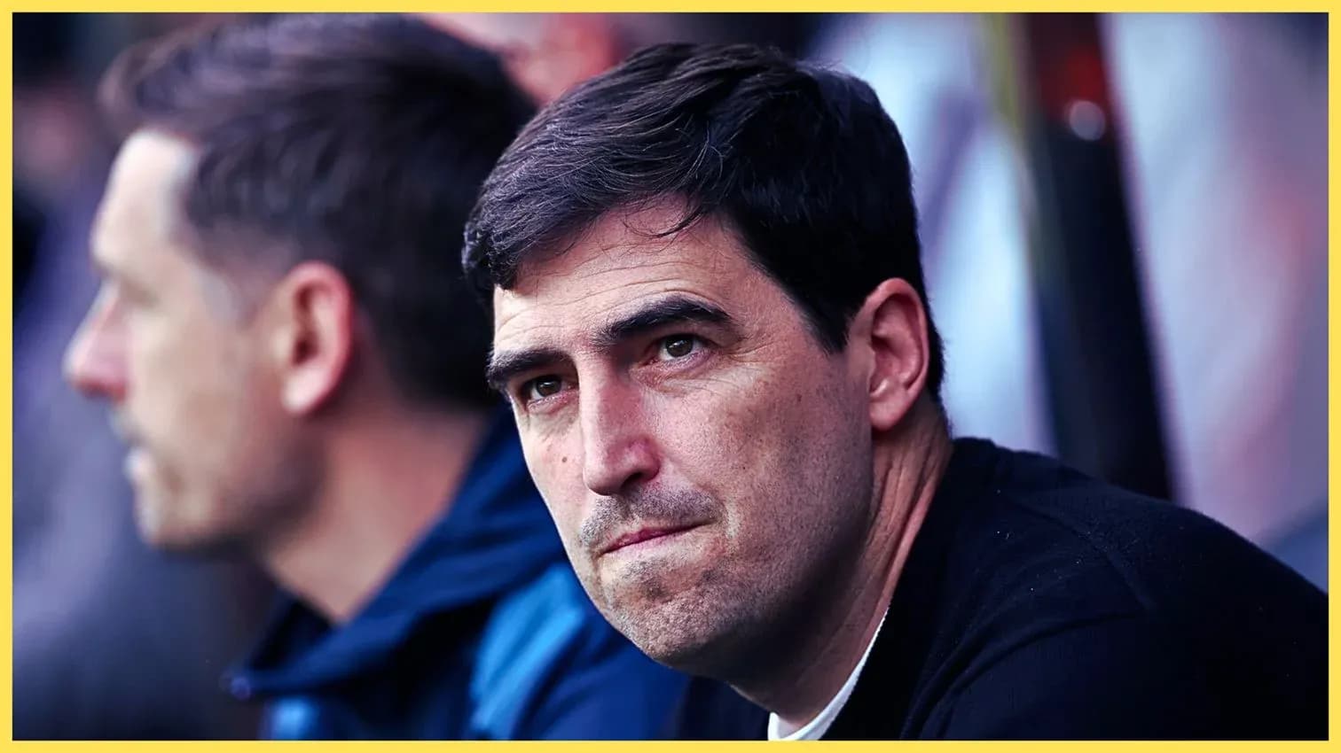 Coach observing the match from the sidelines