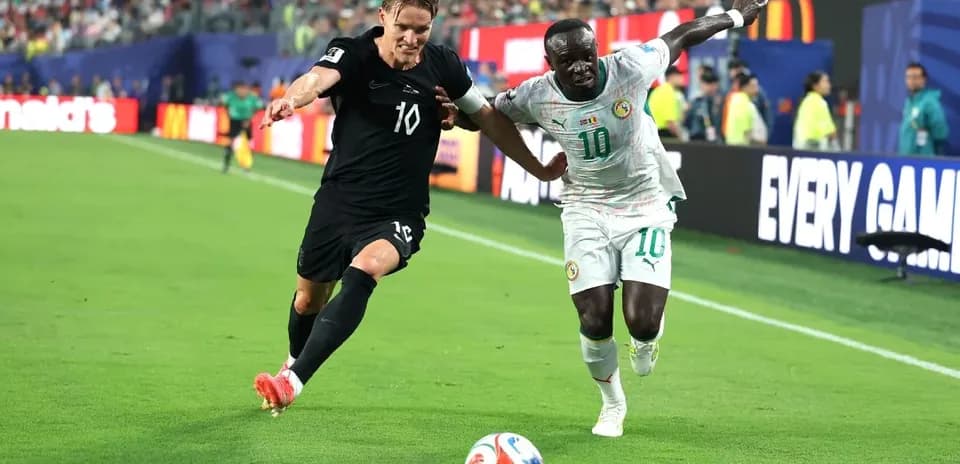 Two players competing for the ball on field