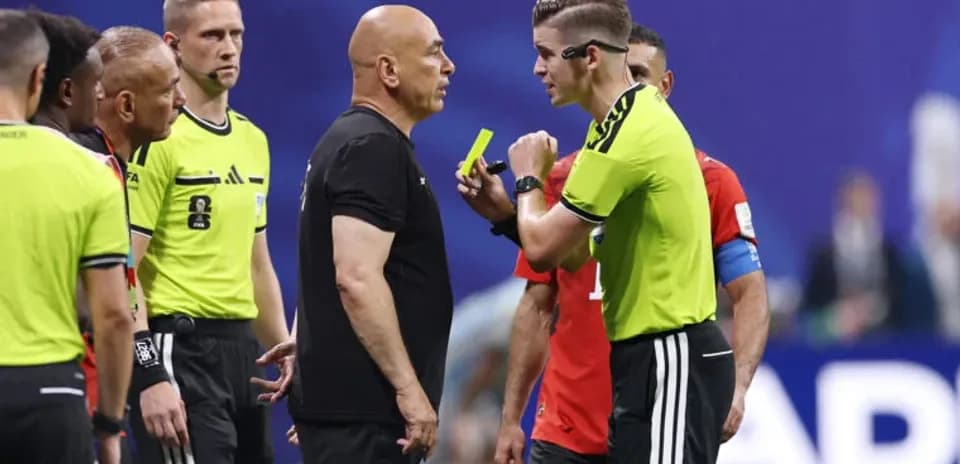 Referee discussing with team officials during match