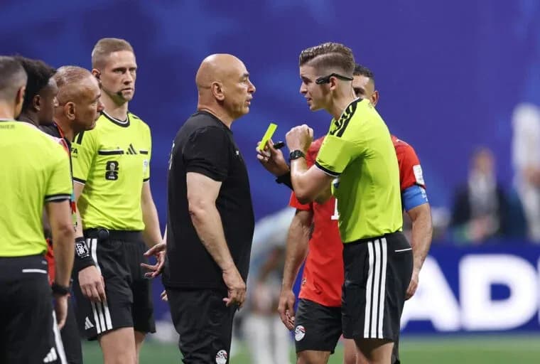 Referee discussing with team officials during match