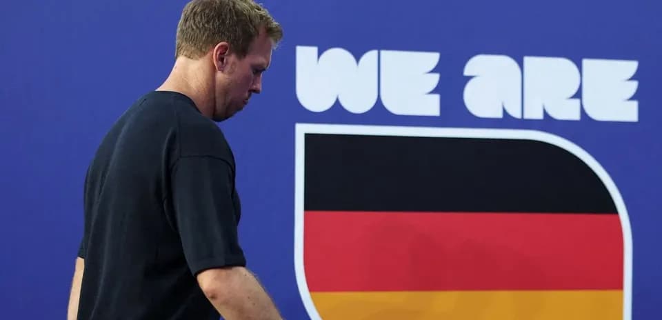 Athlete walking past German flag mural