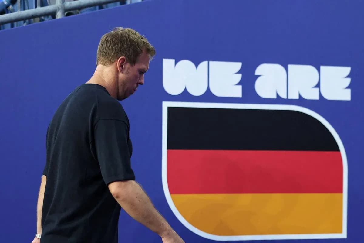 Athlete walking past German flag mural