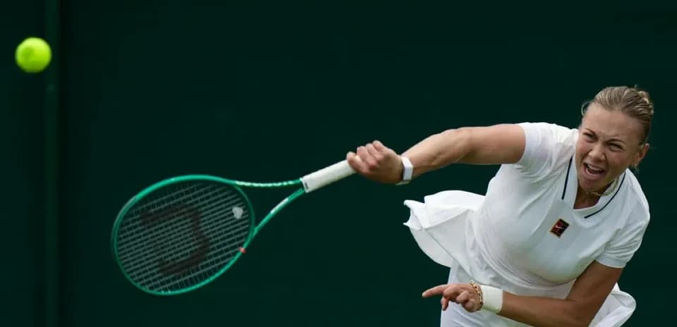 Tennis player serving during match at Wimbledon