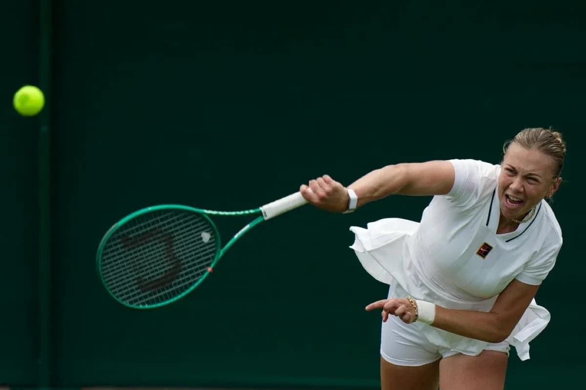 Tennis player serving during match at Wimbledon