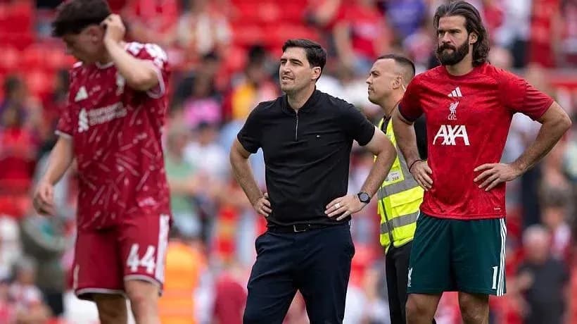 Liverpool players and staff on the pitch during match