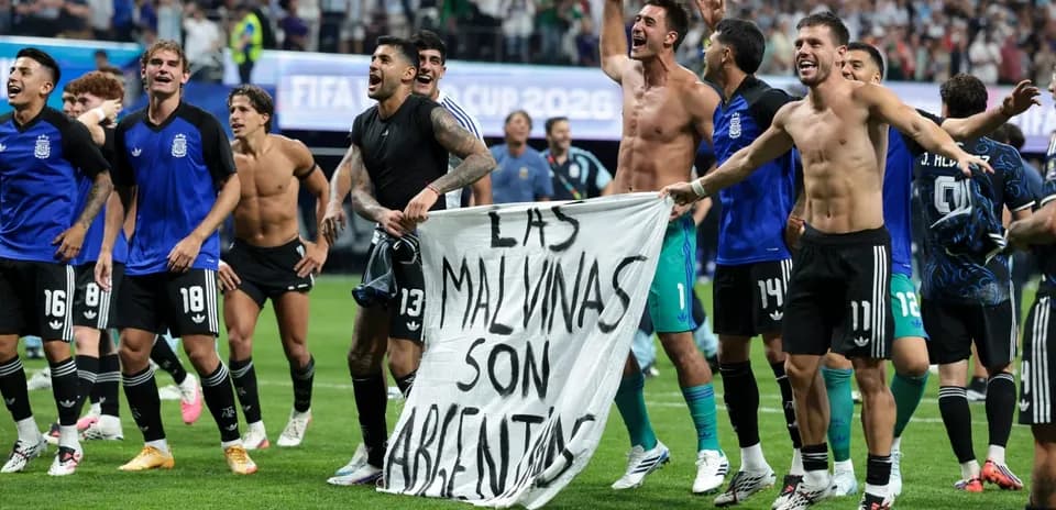 Argentine players celebrating with banner after match