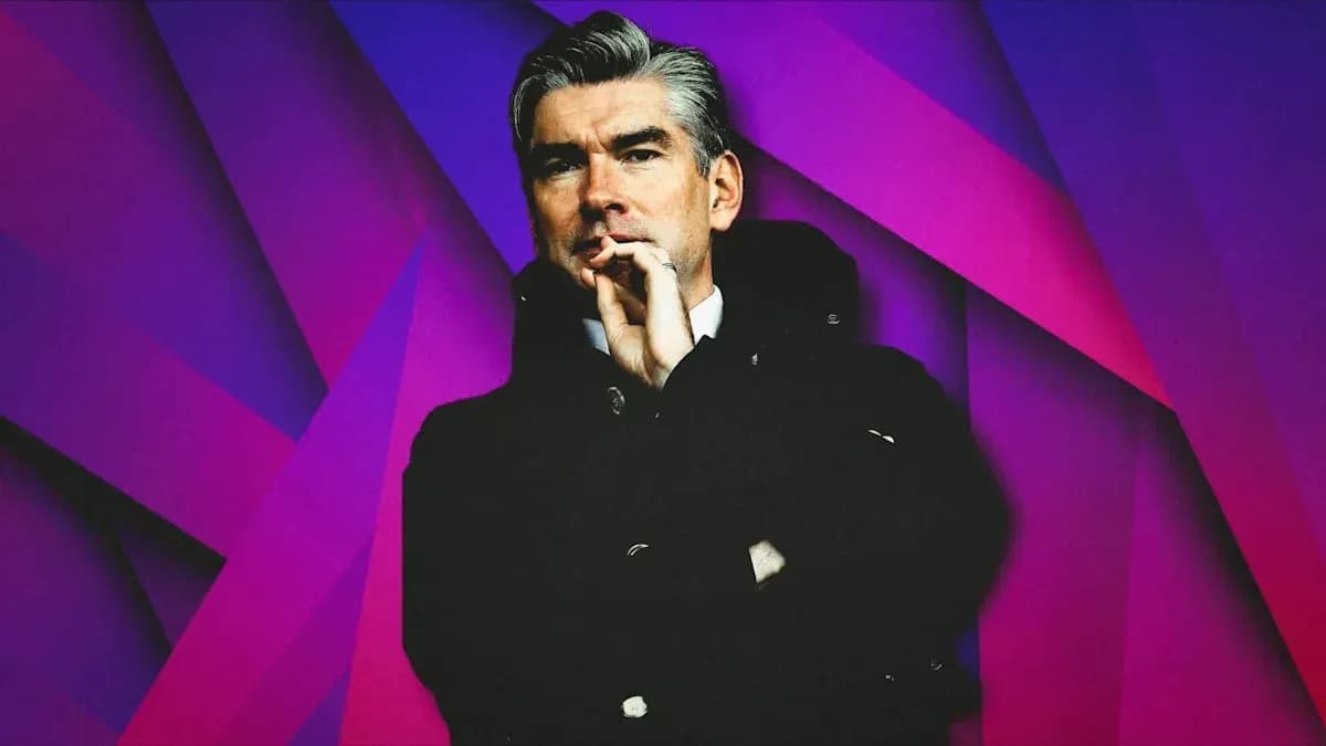 Person in coat posing against colorful background