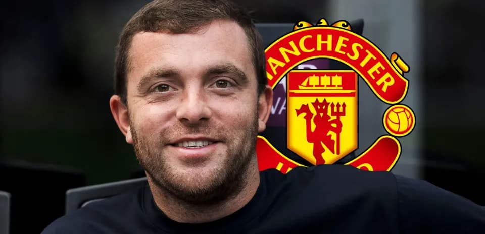 Shirtless man smiling with Manchester United logo behind