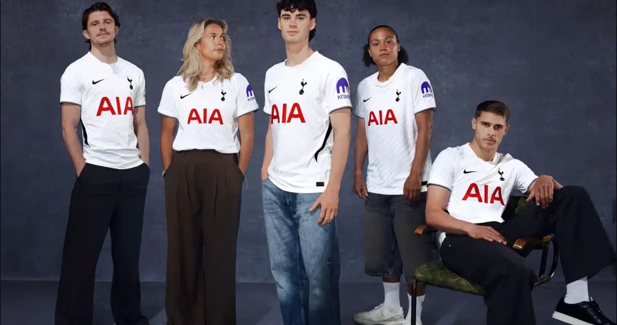 Five people wearing Tottenham jerseys posing together