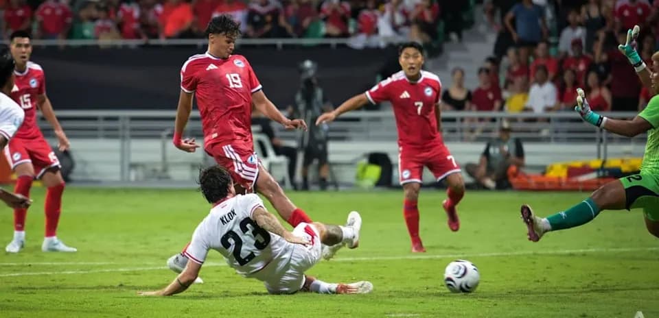 Player sliding for the ball during soccer match