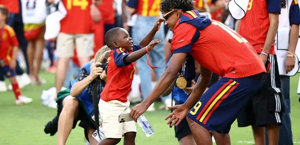 Boys celebrating together on the field after match