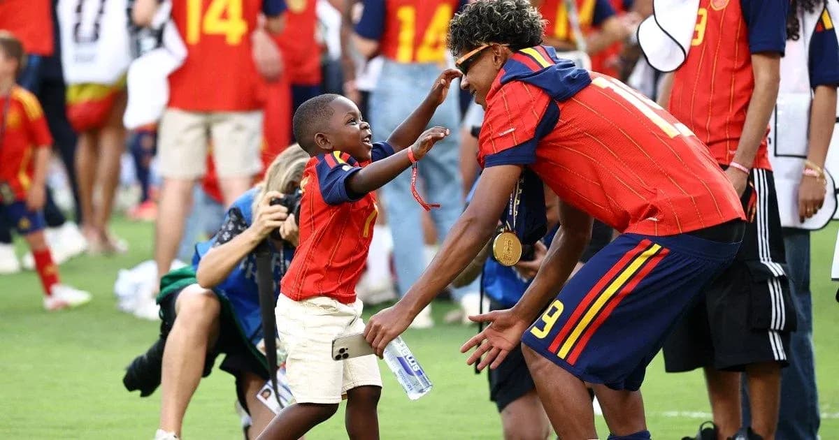 Boys celebrating together on the field after match