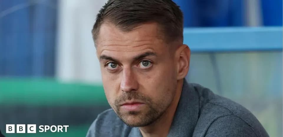 Man sitting and looking intently at camera