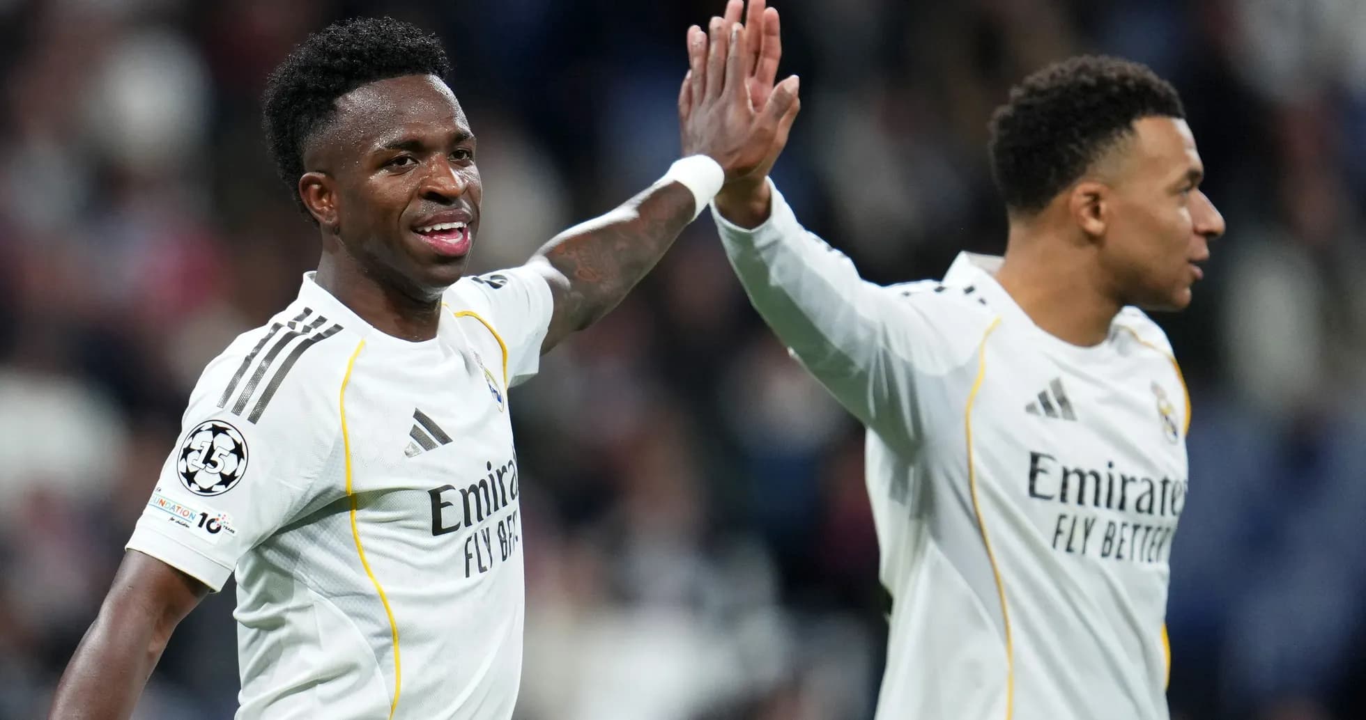 Vinícius Júnior celebrating with teammate during match