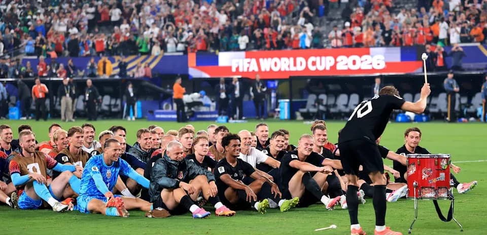 Football team celebrating with drums after match