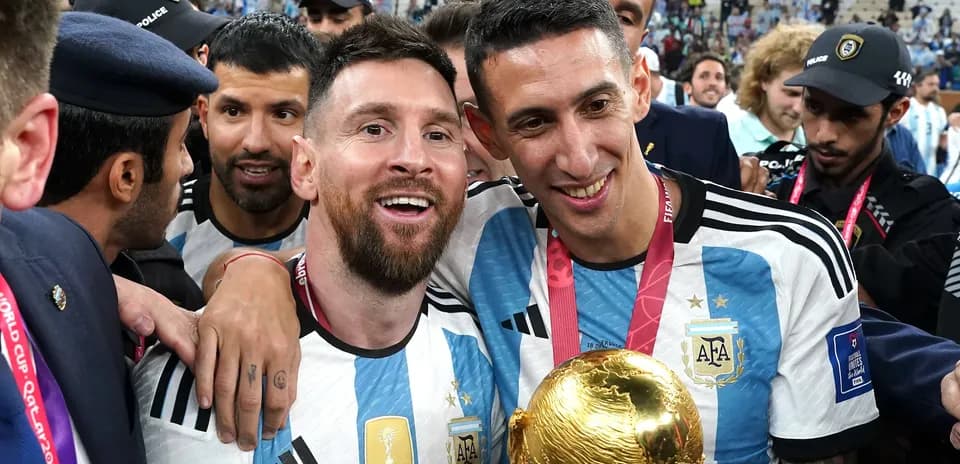 Lionel Messi and Ángel Di María celebrating with trophy