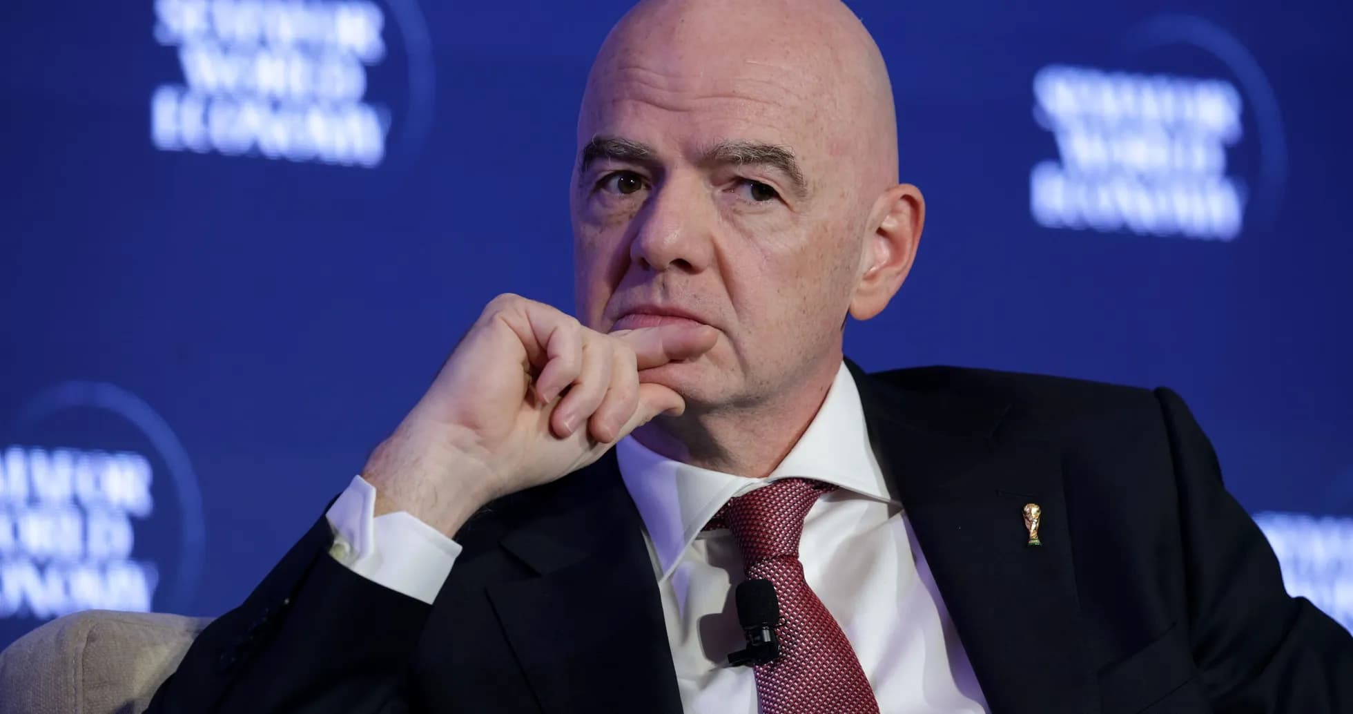 Man in suit during conference with thoughtful expression Man in suit during conference with thoughtful expression