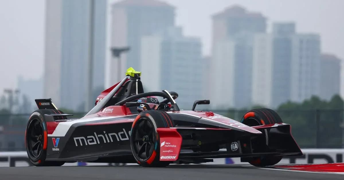 Mahindra racing car on track with city skyline background Mahindra racing car on track with city skyline background