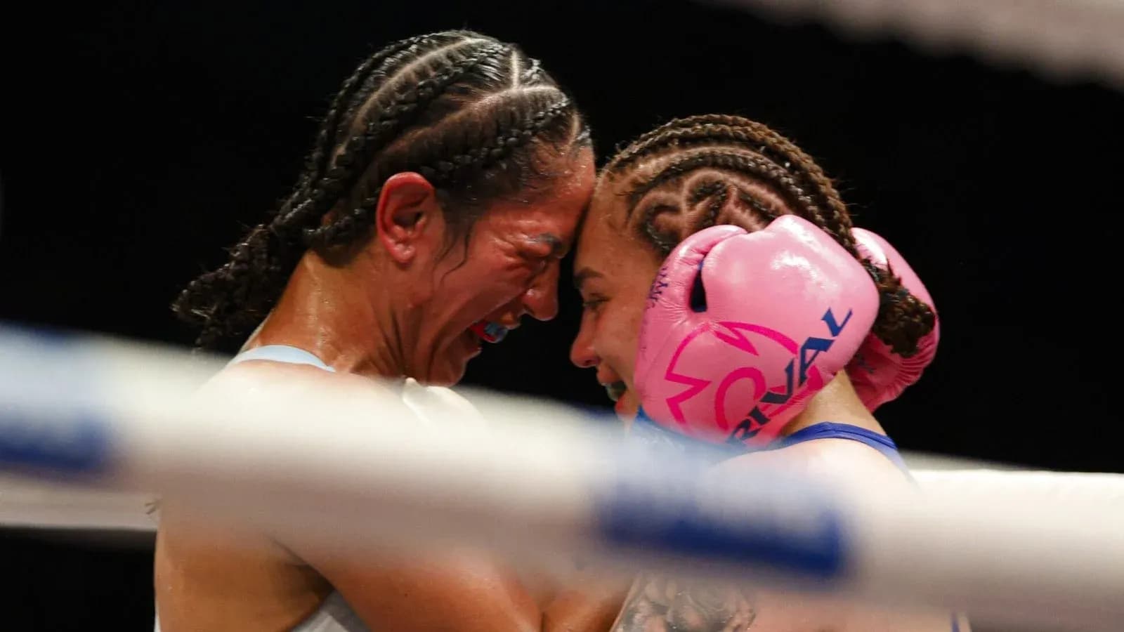 Two female boxers embracing in the ring Two female boxers embracing in the ring