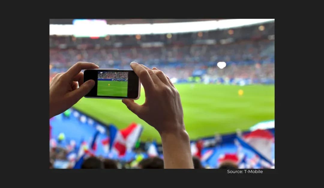 Fan recording football match with smartphone in stadium Fan recording football match with smartphone in stadium