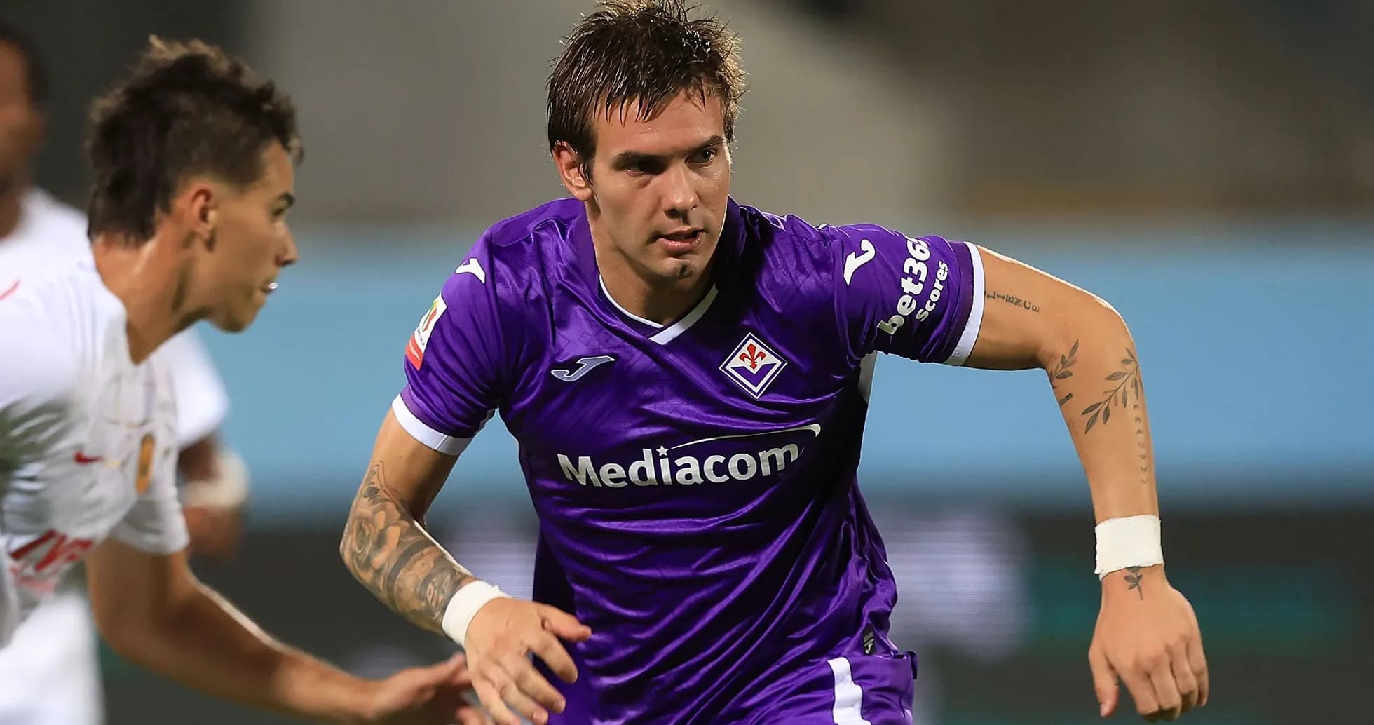 Fiorentina player dribbling during a match Fiorentina player dribbling during a match