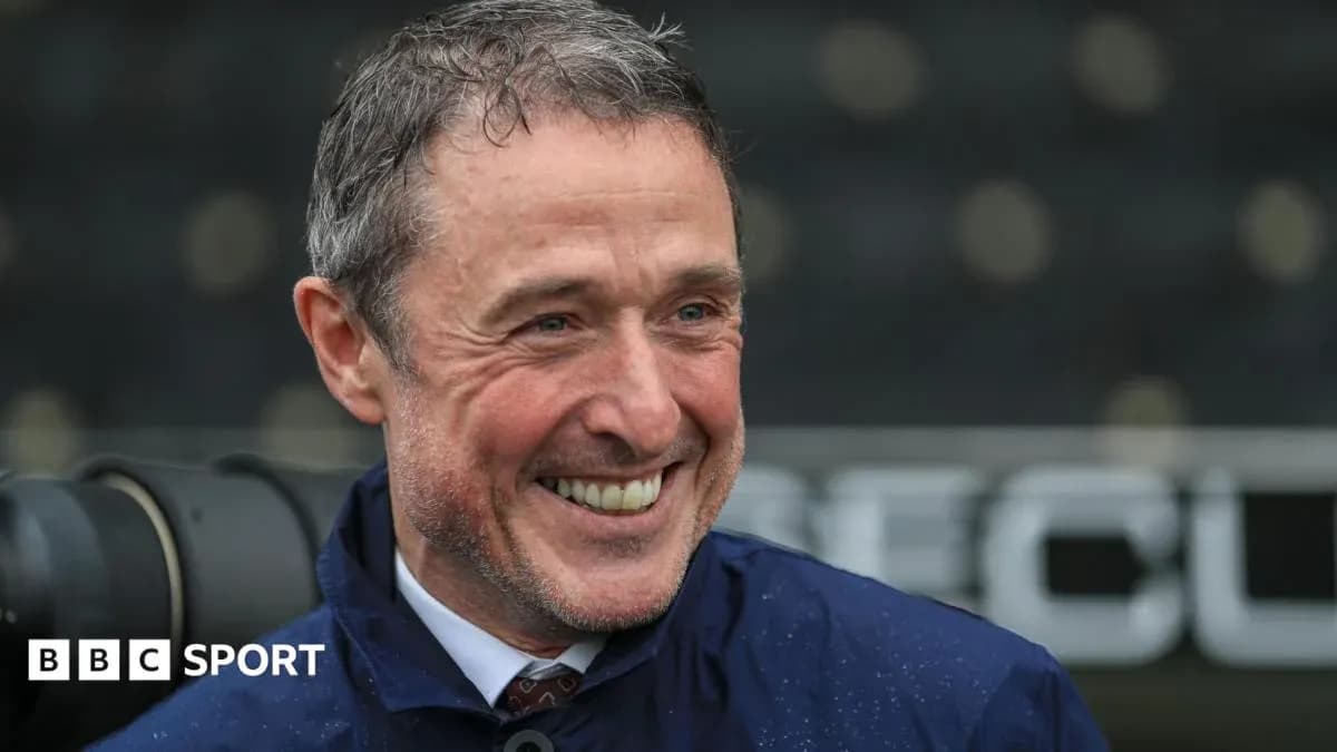 Coach smiling during a rainy match day Coach smiling during a rainy match day