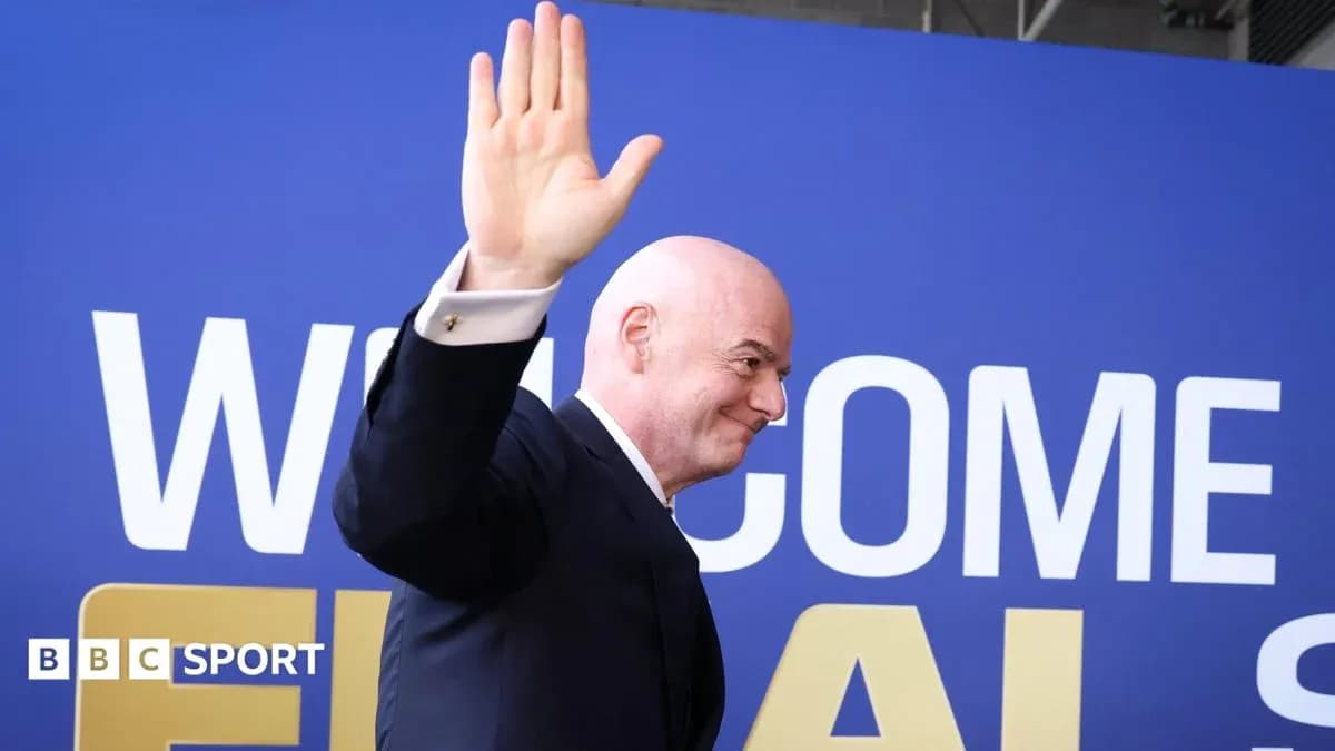 Man waving at event with welcome banner behind Man waving at event with welcome banner behind