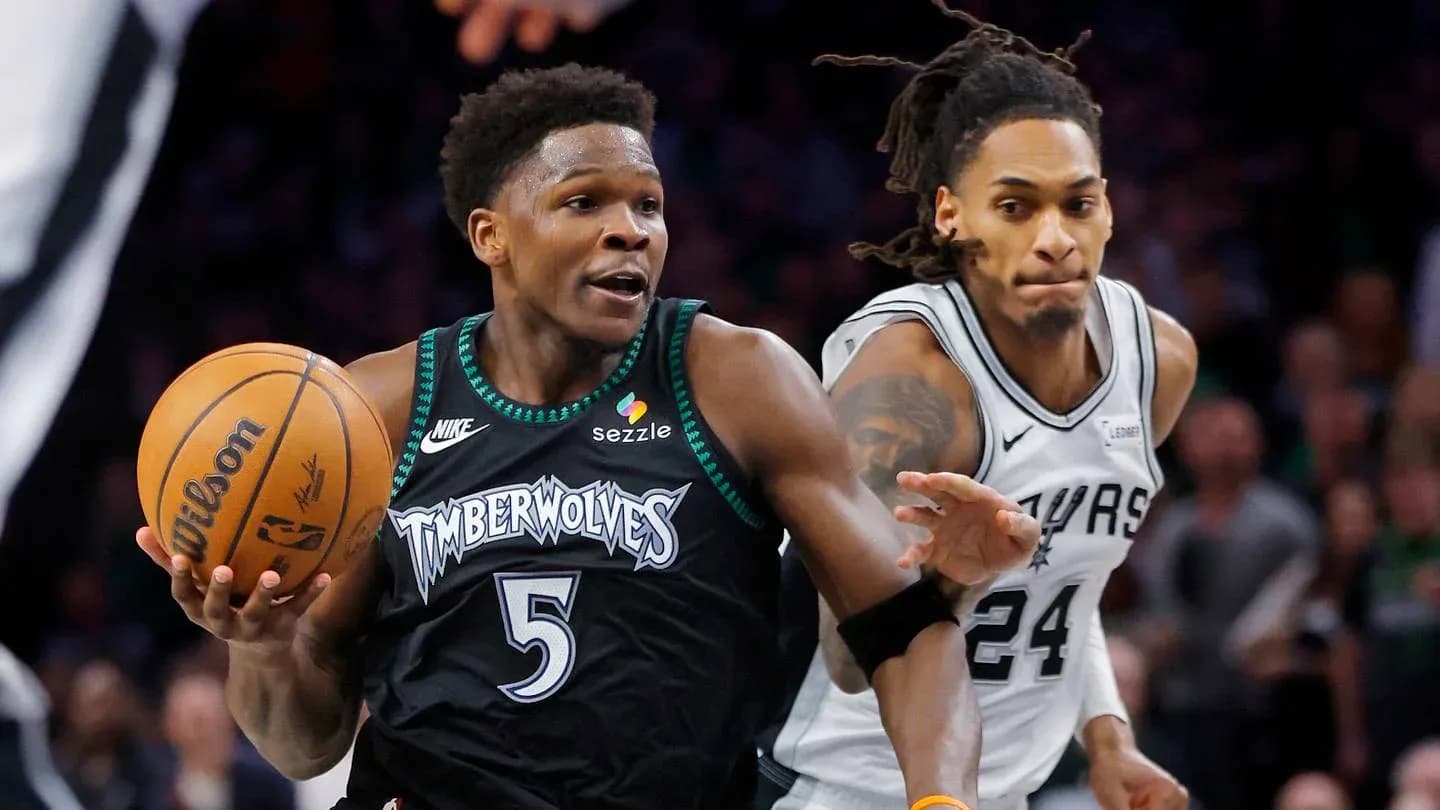 Timberwolves player dribbling past Spurs defender Timberwolves player dribbling past Spurs defender