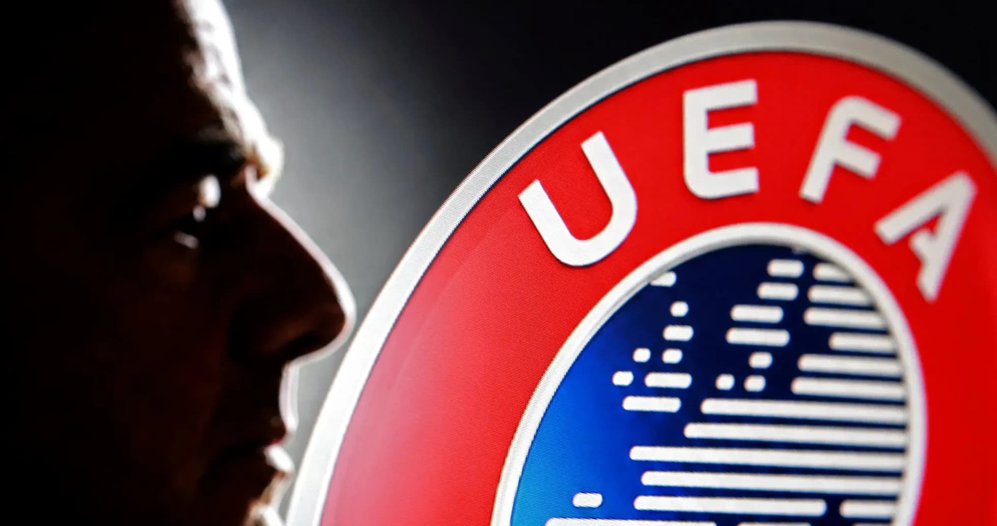 Shadows of a man next to UEFA logo Shadows of a man next to UEFA logo