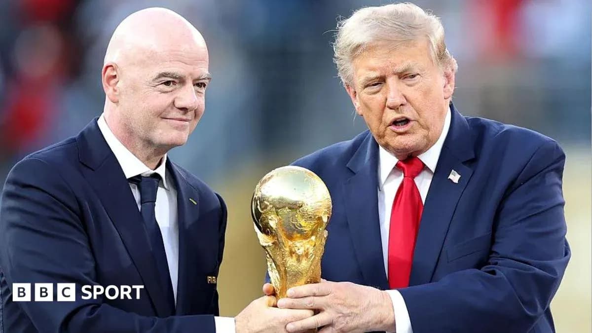 FIFA president and official holding World Cup trophy FIFA president and official holding World Cup trophy