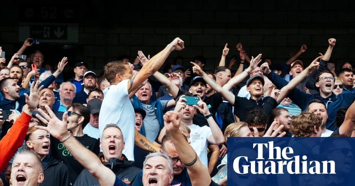 Football fans cheering passionately in the stands Football fans cheering passionately in the stands