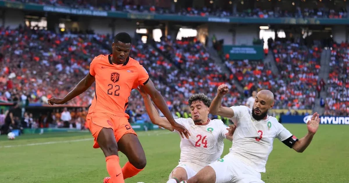 Holland player dribbling past two Moroccan defenders Holland player dribbling past two Moroccan defenders