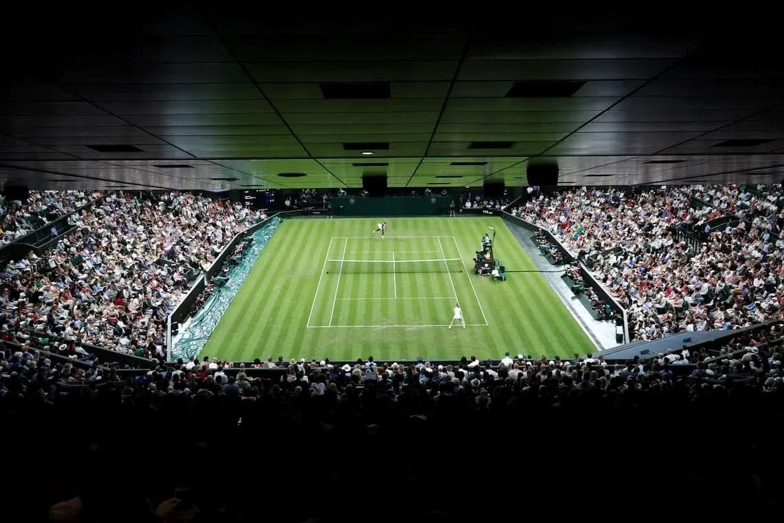 Tennis match in progress at Wimbledon stadium Tennis match in progress at Wimbledon stadium