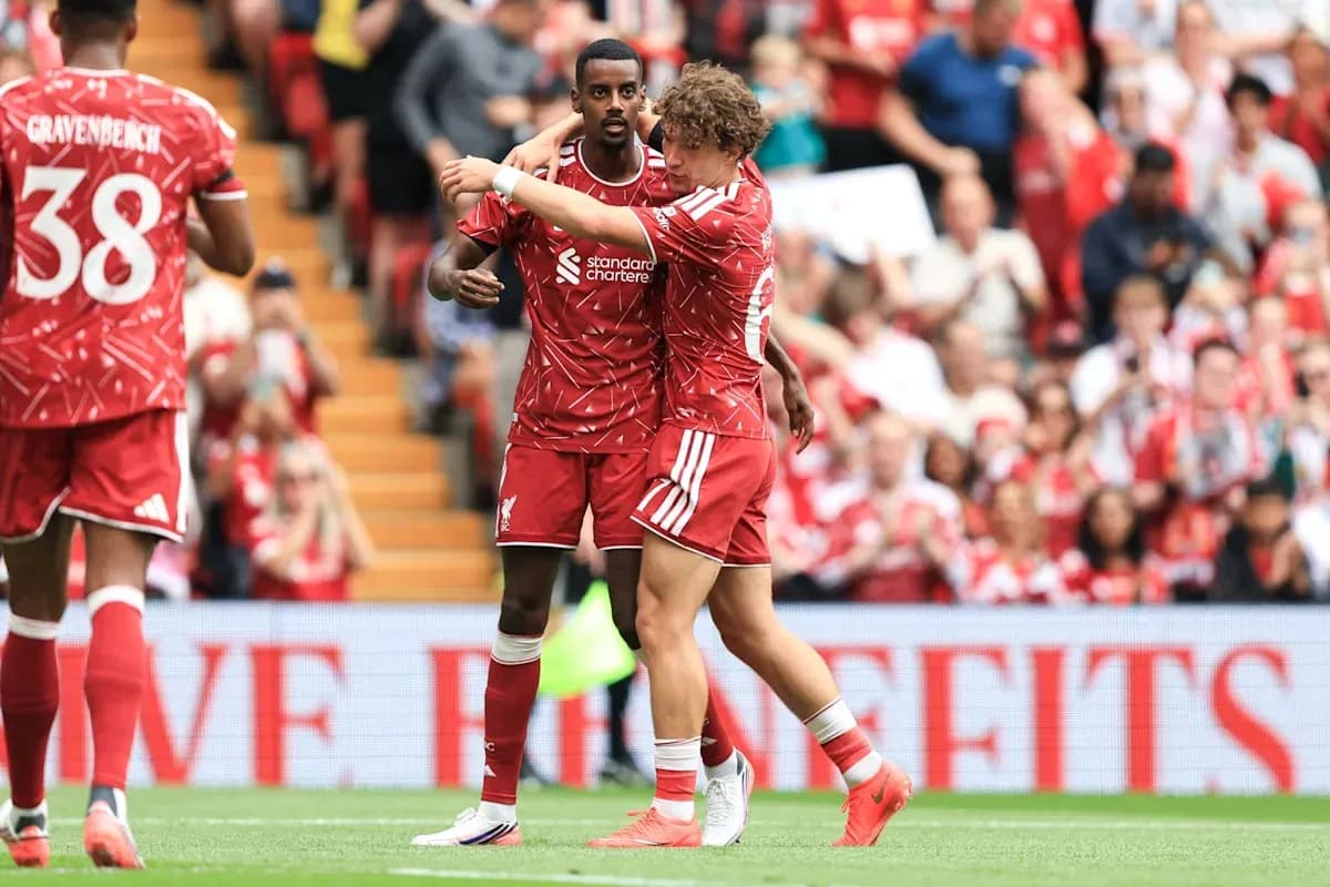 Liverpool players celebrating a goal on the pitch Liverpool players celebrating a goal on the pitch