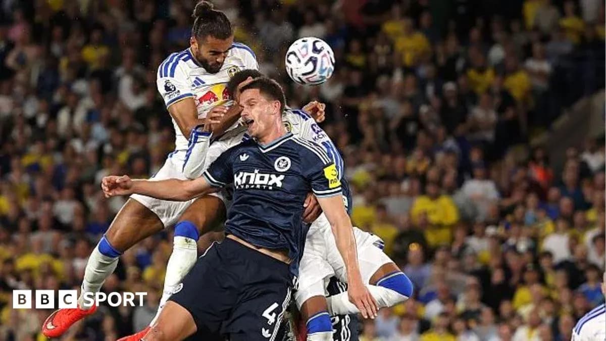 Two players colliding during a football match Two players colliding during a football match