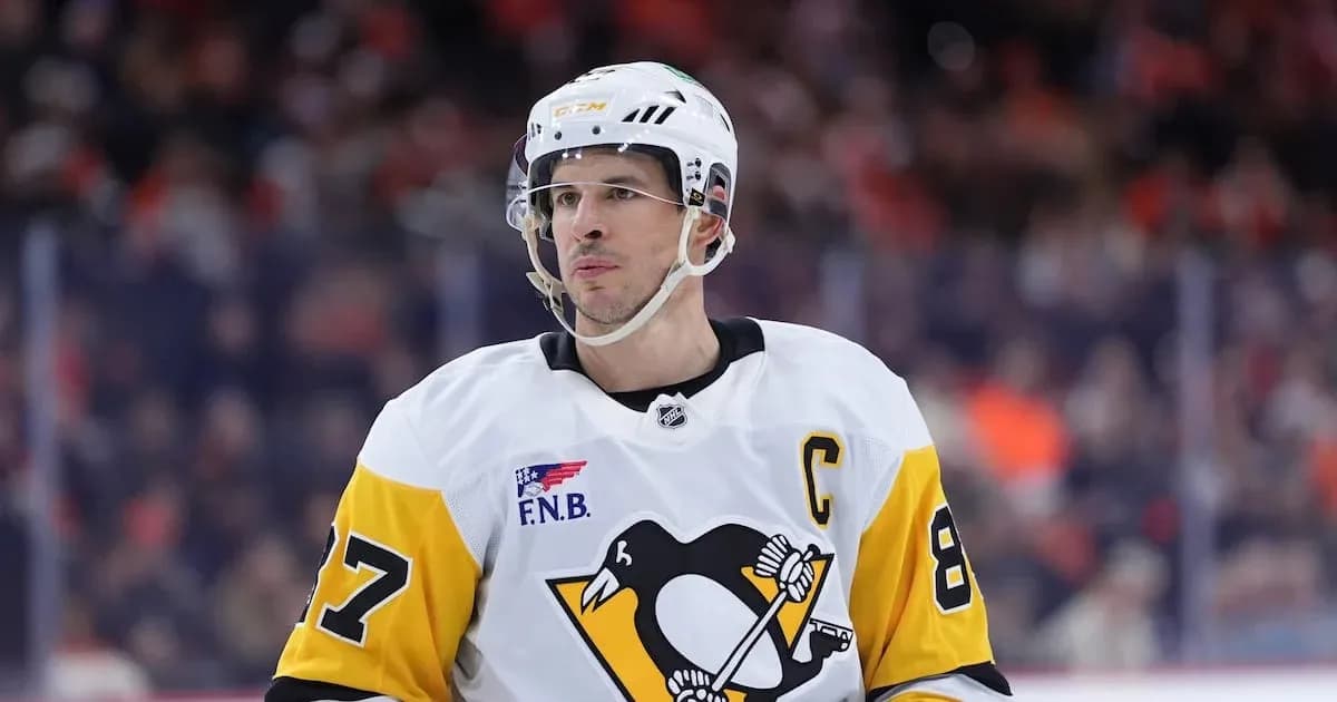 Hockey player wearing Penguins jersey on ice rink Hockey player wearing Penguins jersey on ice rink