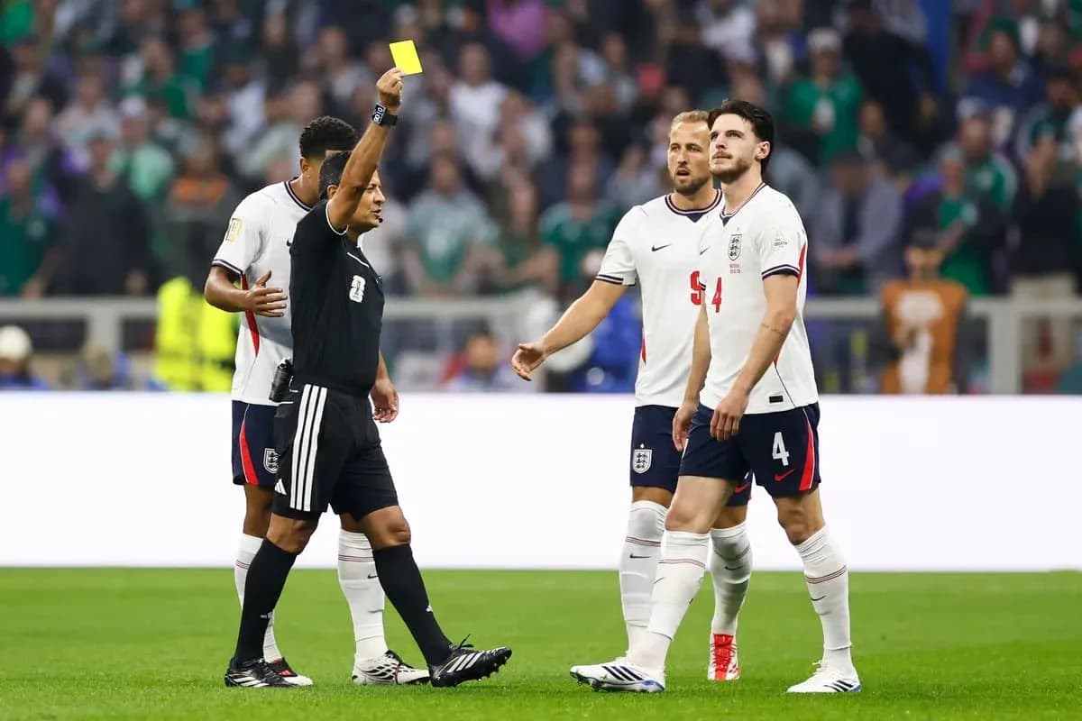 Referee showing yellow card to England player Referee showing yellow card to England player