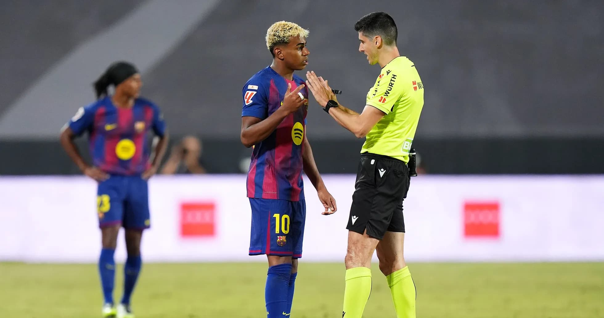 Barcelona player discussing with referee during match Barcelona player discussing with referee during match