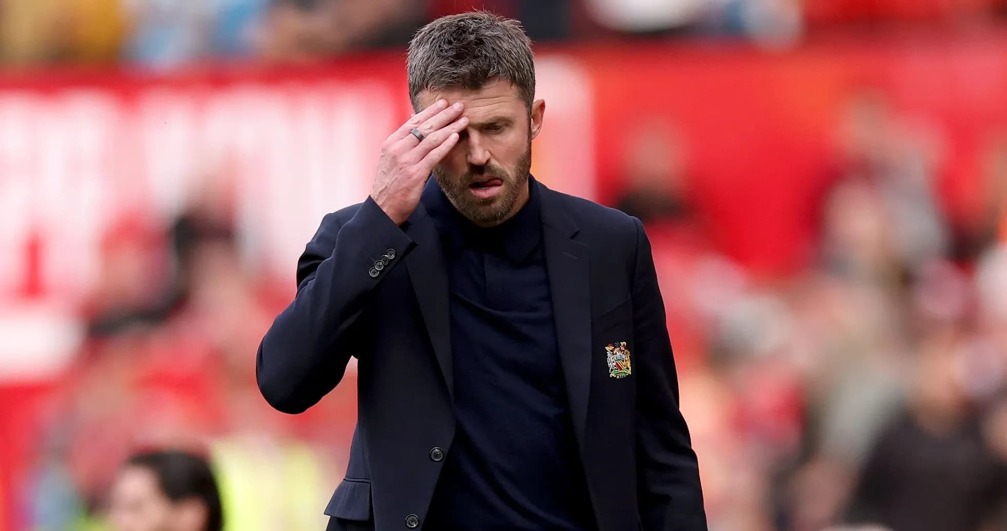 Men's football coach walking on the pitch Men's football coach walking on the pitch