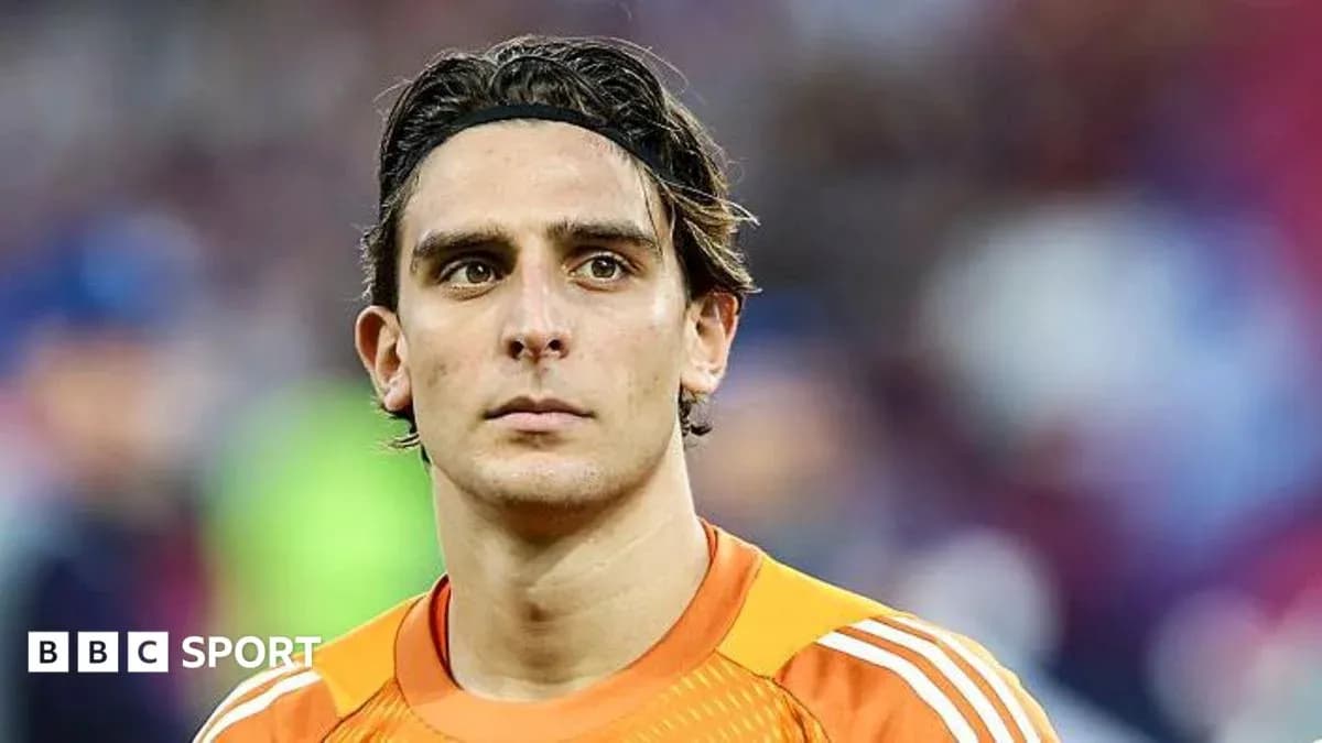 Goalkeeper in orange jersey during match Goalkeeper in orange jersey during match