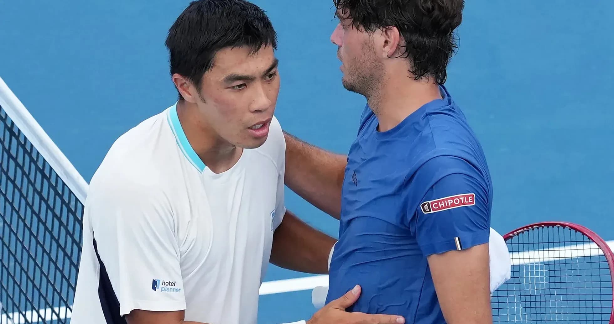 Two tennis players shaking hands at net Two tennis players shaking hands at net