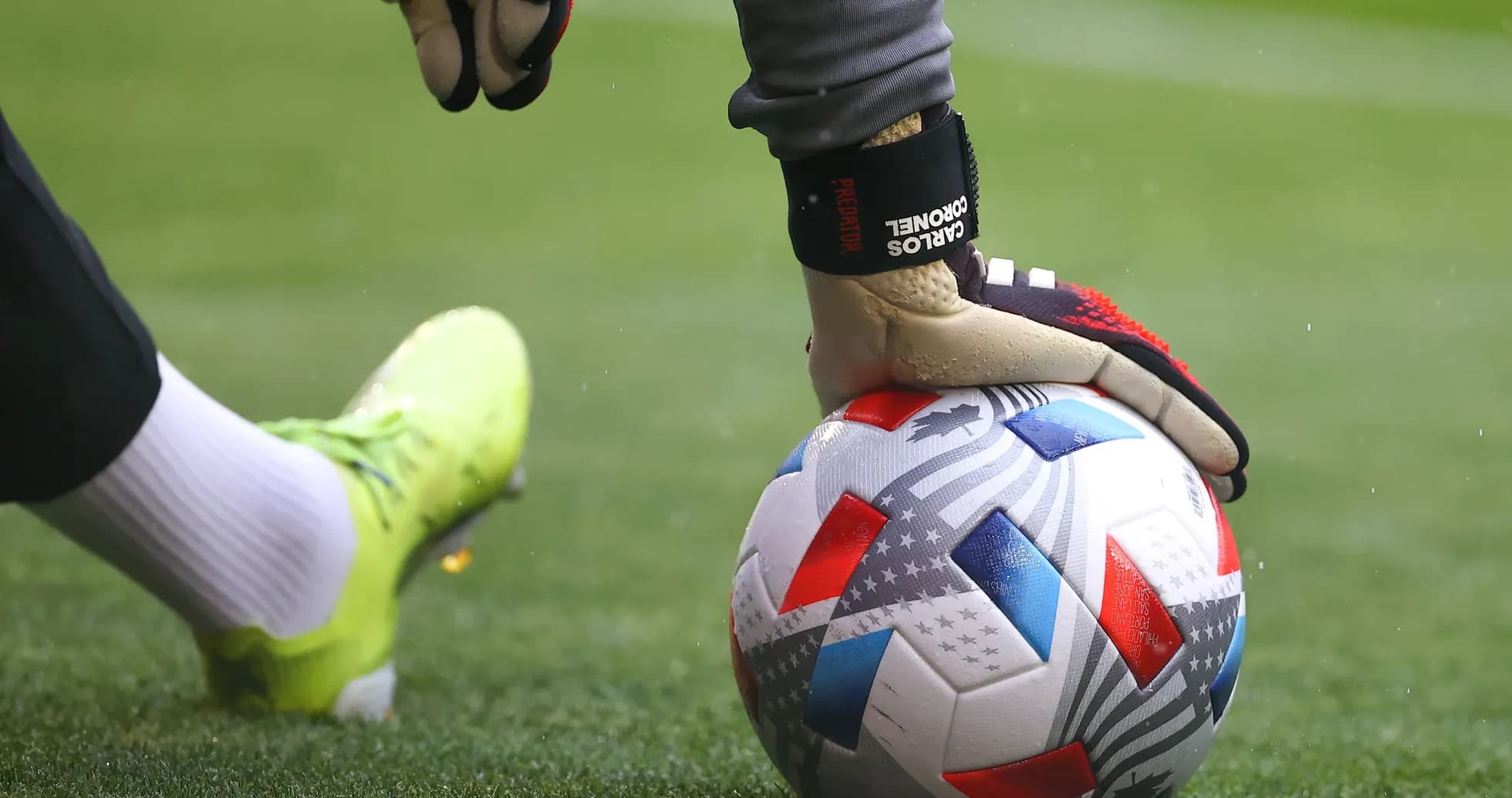 Goalkeeper holding a soccer ball on the field Goalkeeper holding a soccer ball on the field
