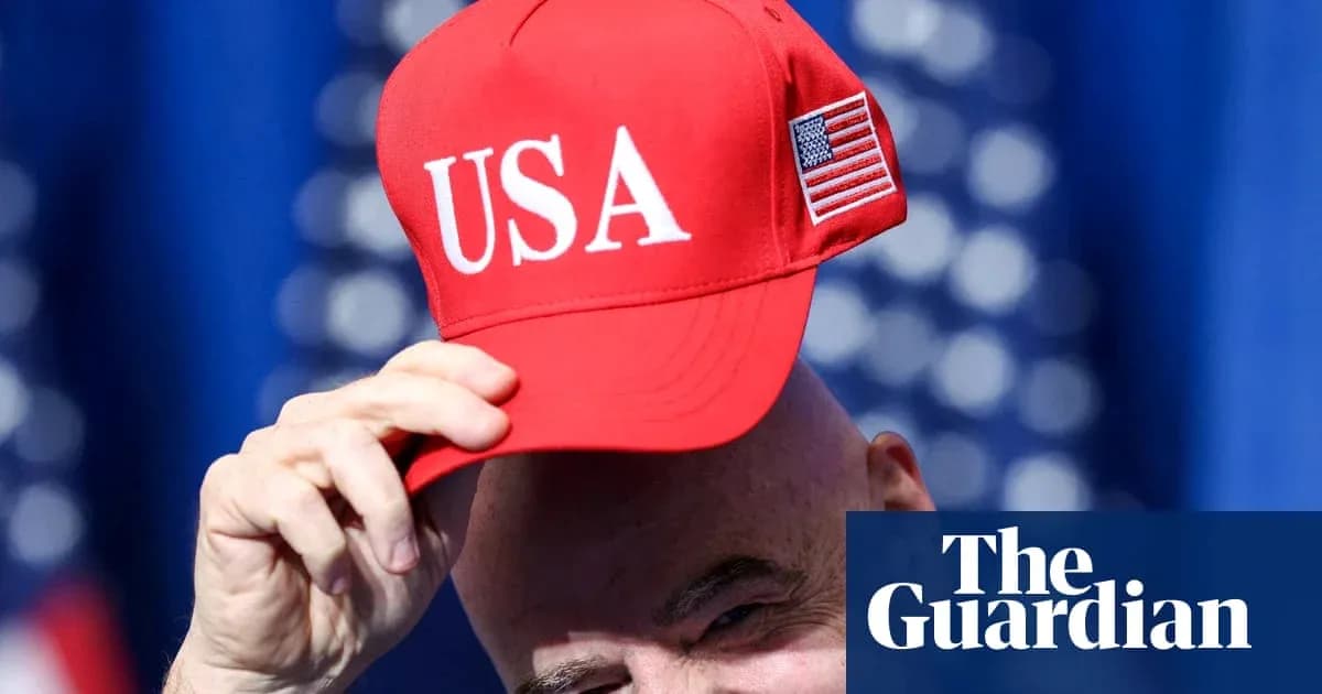 Bald man holding red USA cap at event Bald man holding red USA cap at event