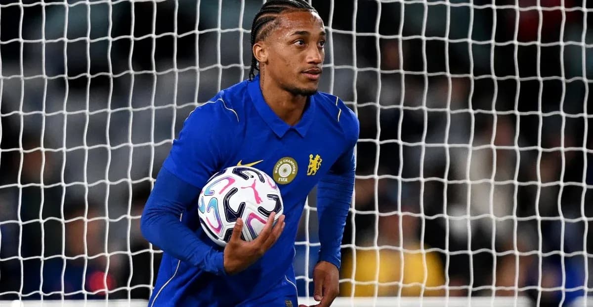 Goalkeeper holding ball in front of goal net Goalkeeper holding ball in front of goal net
