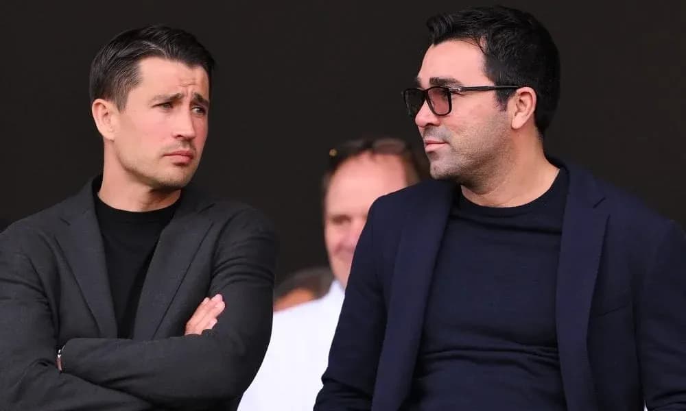 Two men conversing in a sports venue Two men conversing in a sports venue