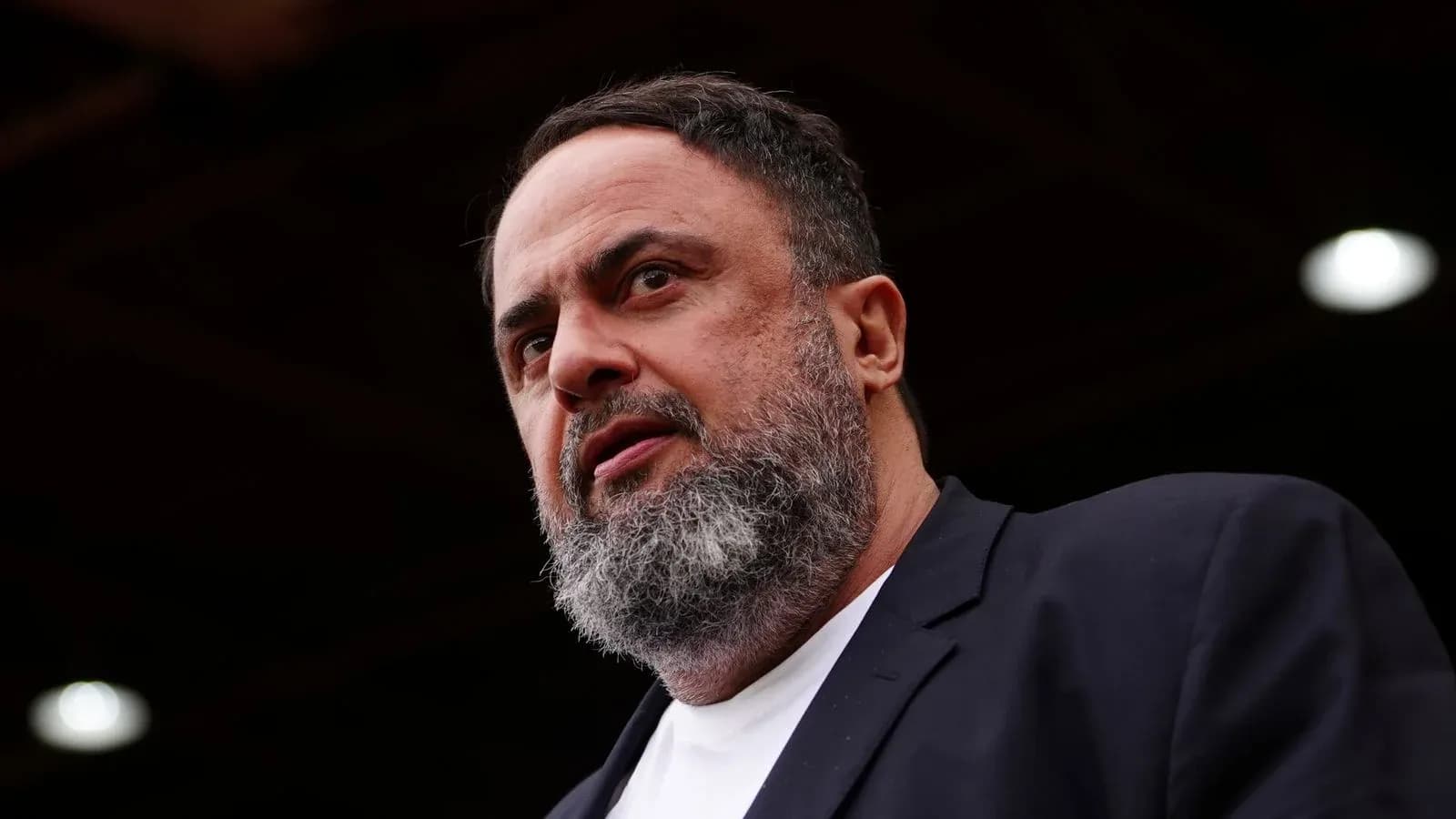 Shirtless man with beard speaking at event Shirtless man with beard speaking at event