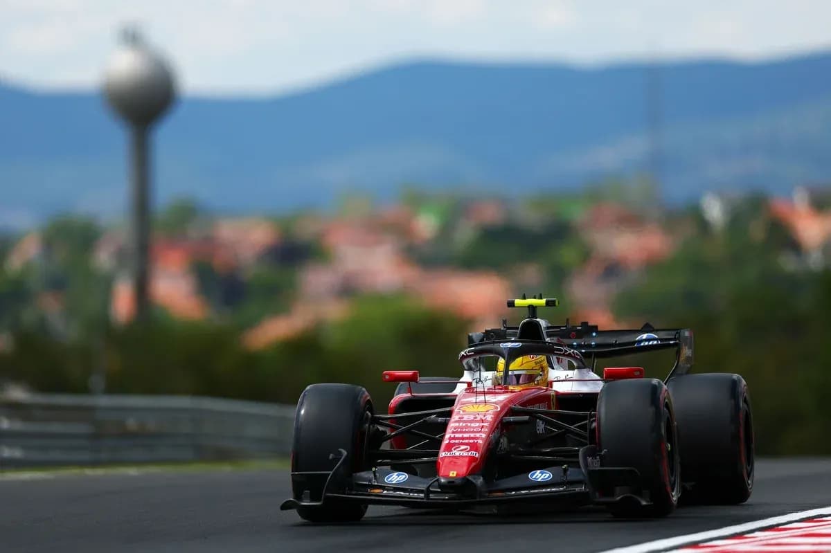 Ferrari F1 car racing on track with mountains background Ferrari F1 car racing on track with mountains background