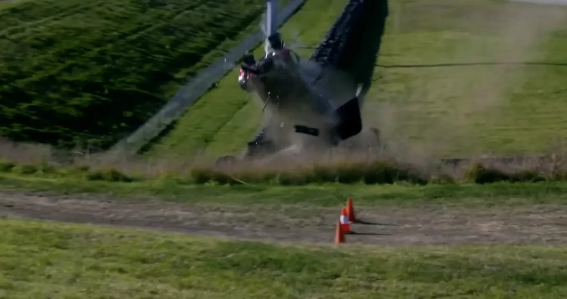 Helicopter crashing on grassy terrain with cones Helicopter crashing on grassy terrain with cones