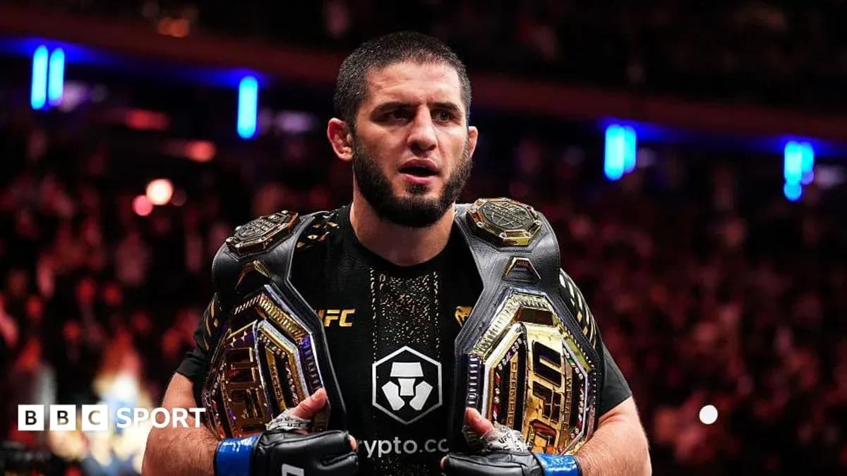 UFC champion holding two championship belts UFC champion holding two championship belts