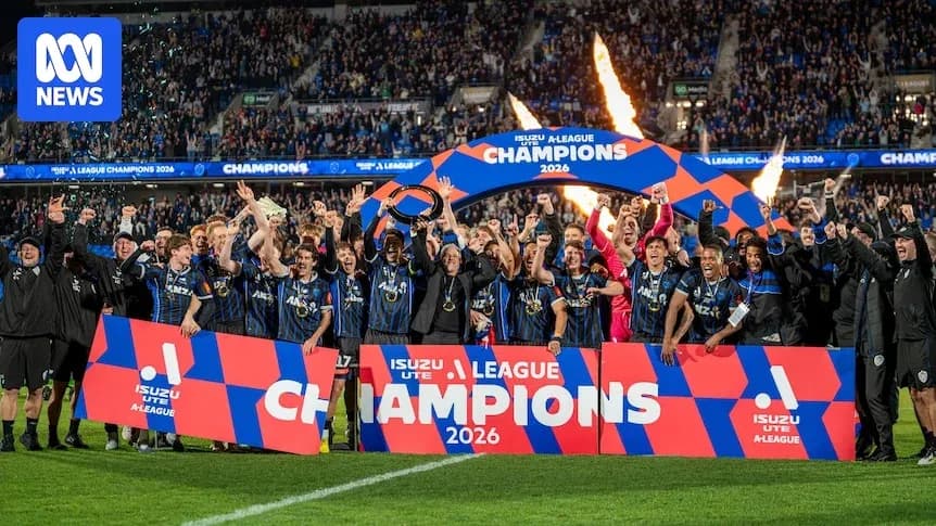 Team celebrating victory with champions banner Team celebrating victory with champions banner